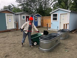Volunteer filling planters at the developing T.C. Spirit Tiny House Village