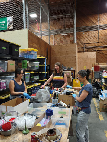 Volunteers sorting home goods and kitchenware