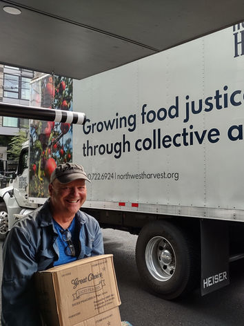 Volunteer helping to unload donated food at the Good Shepherd House