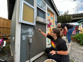Volunteer adding a fresh coat of paint to the case manager's office at Interbay THV
